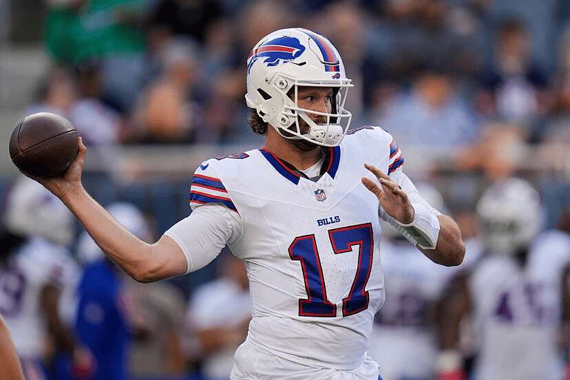 Josh Allen Buffalo Bills quarterback number 17 throwing football in white away jersey during game action