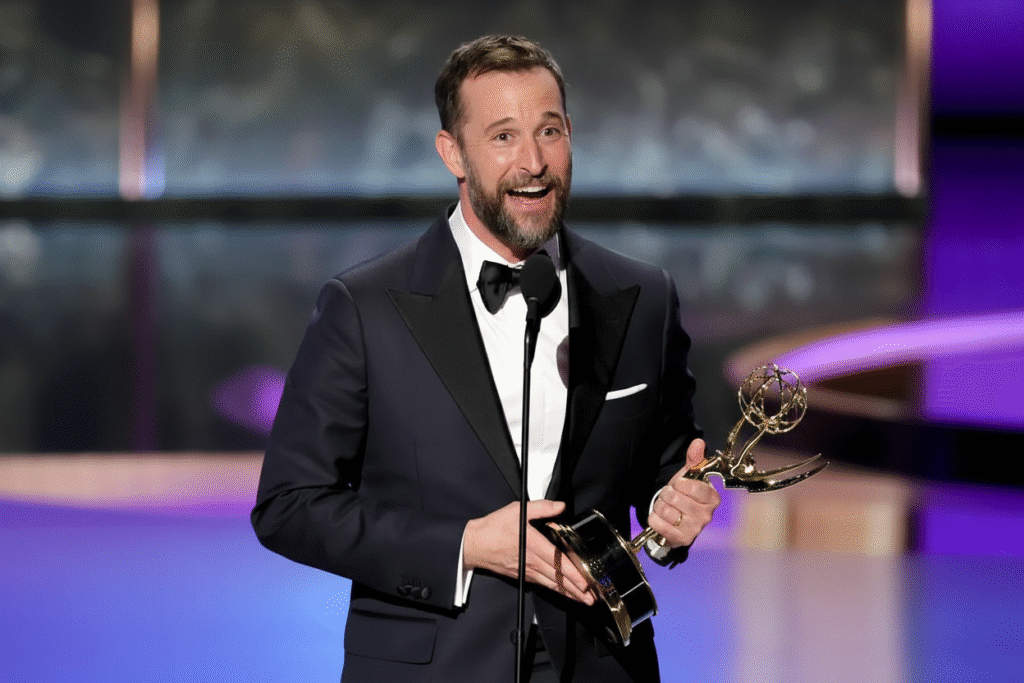 oah Wyle in brown velvet tuxedo holds Emmy trophy while speaking at podium during 2025 Emmy Awards acceptance speech for Outstanding Lead Actor Drama Series
This historic win marked Wyle's return to medical drama excellence and honored the healthcare professionals who inspired "The Pitt's" authentic portrayal of emergency medicine.