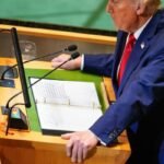Trump UN speech 2025 at UN podium, top-down view with teleprompter and binder