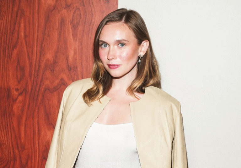 Image editing interface showing a professional portrait of Veronika Slowikowska, Canadian comedian and new SNL cast member, wearing a beige blazer against a wood-paneled background